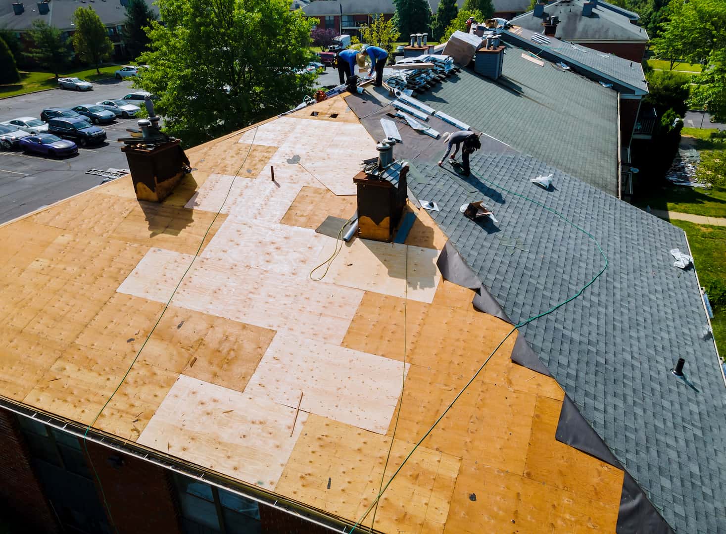 A roofing company performing roof installation on an aerial view.