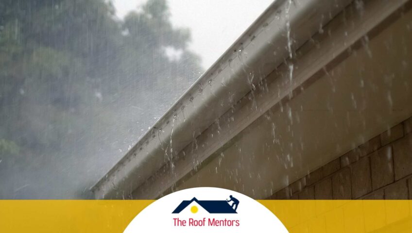 A house with a rain gutter and the words the roofing masters.