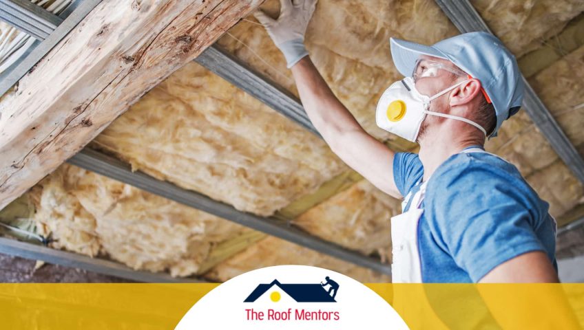 A man wearing a mask and gloves is working on a roof for a roofing company.