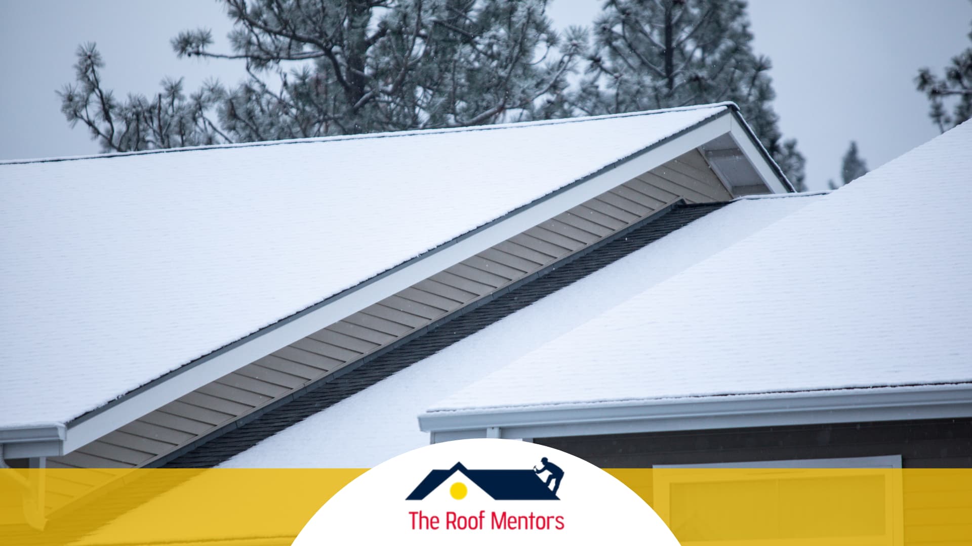 A house with a snow-covered roof showcasing the expertise of The Roof Masters in roof installation.