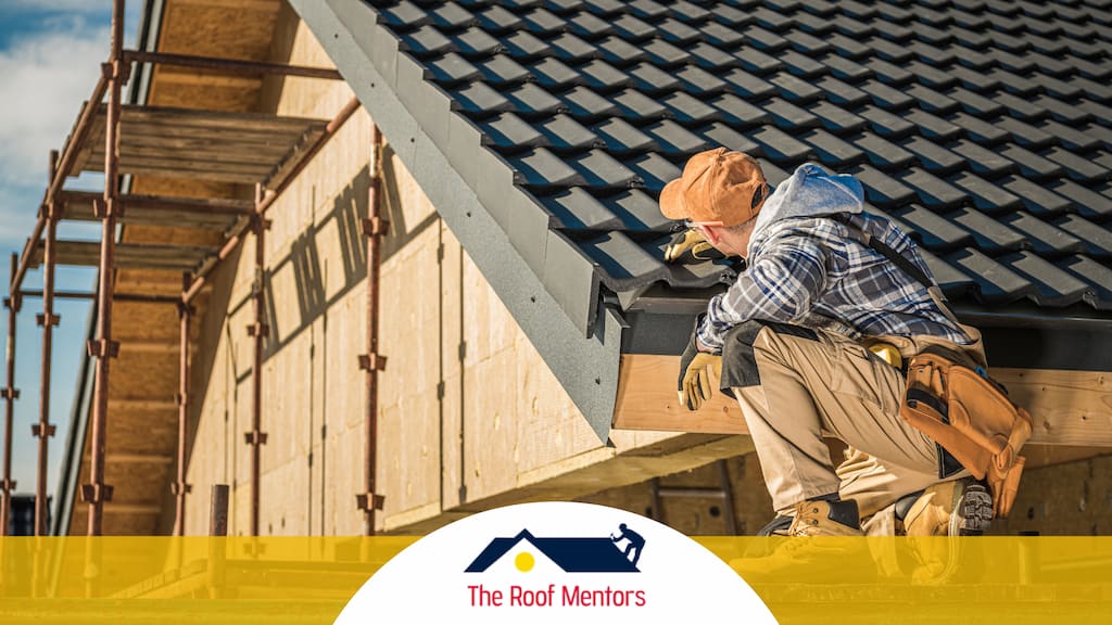 A man is performing roof installation on a house.